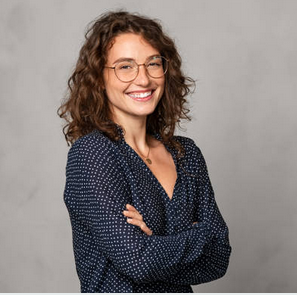 Young woman wearing a skirt and holing a coffee
